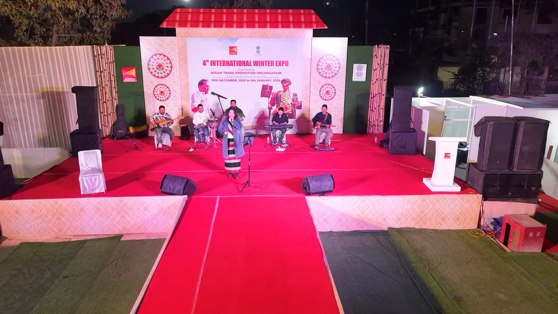 Live music performance by a band on the expo main stage at night