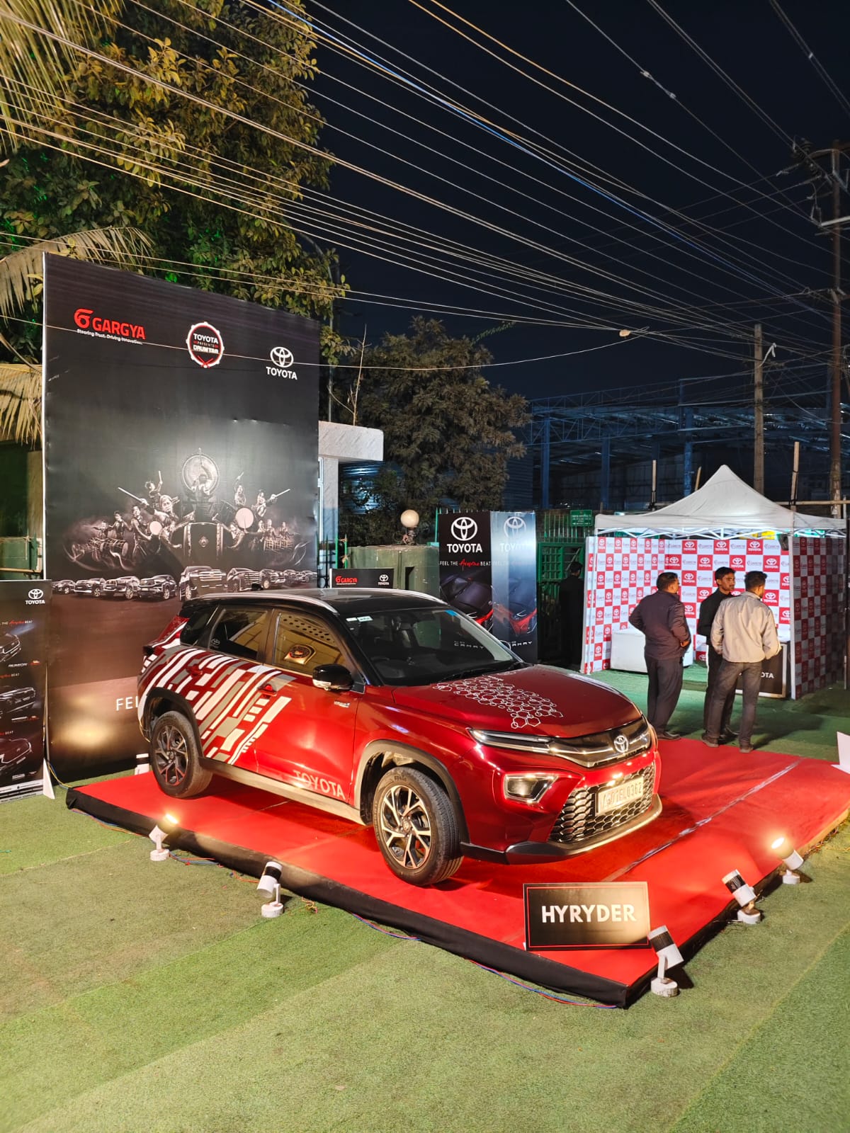 Automobile brand activation with a car displayed on a red carpet at the expo